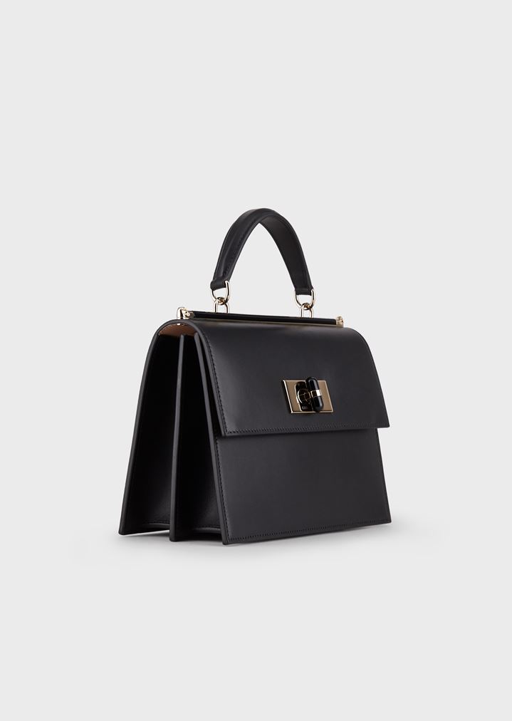 Bolso de mano de piel lisa con cierre giratorio y detalles de plexiglás Bolso de mano de piel lisa con cierre giratorio y detalles de plexiglás