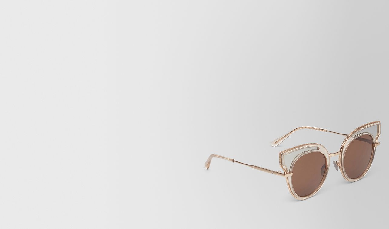 sunglasses in transparent light honey acetate, solid brown lenses landing